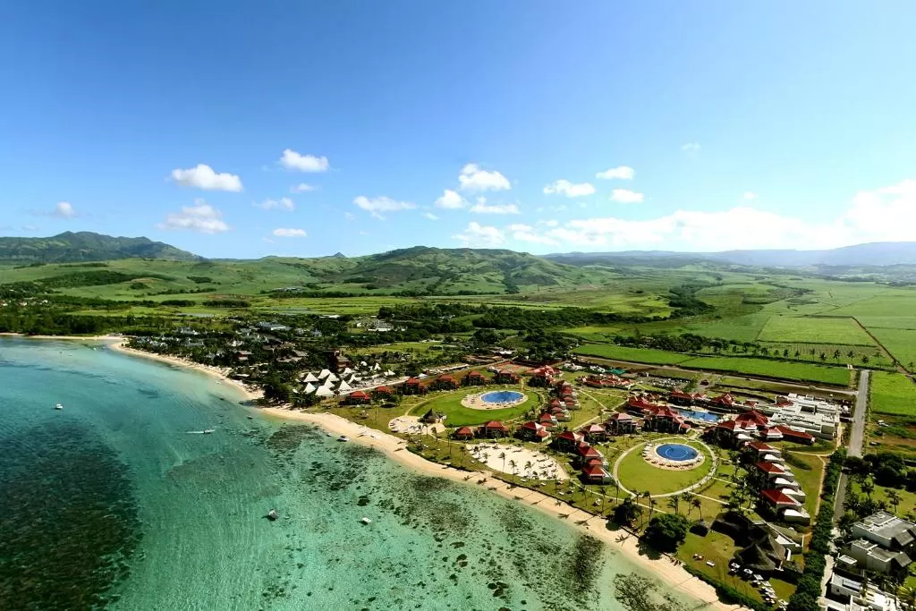 Tamassa - An All Inclusive Resort in Mauritius - Outdoor view with swimming pool and palm trees