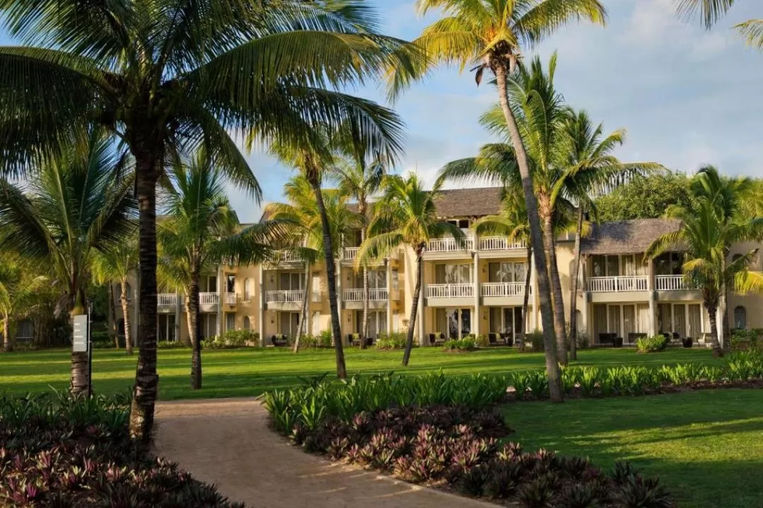 Outrigger Mauritius Beach Resort - Beachfront view with palm trees