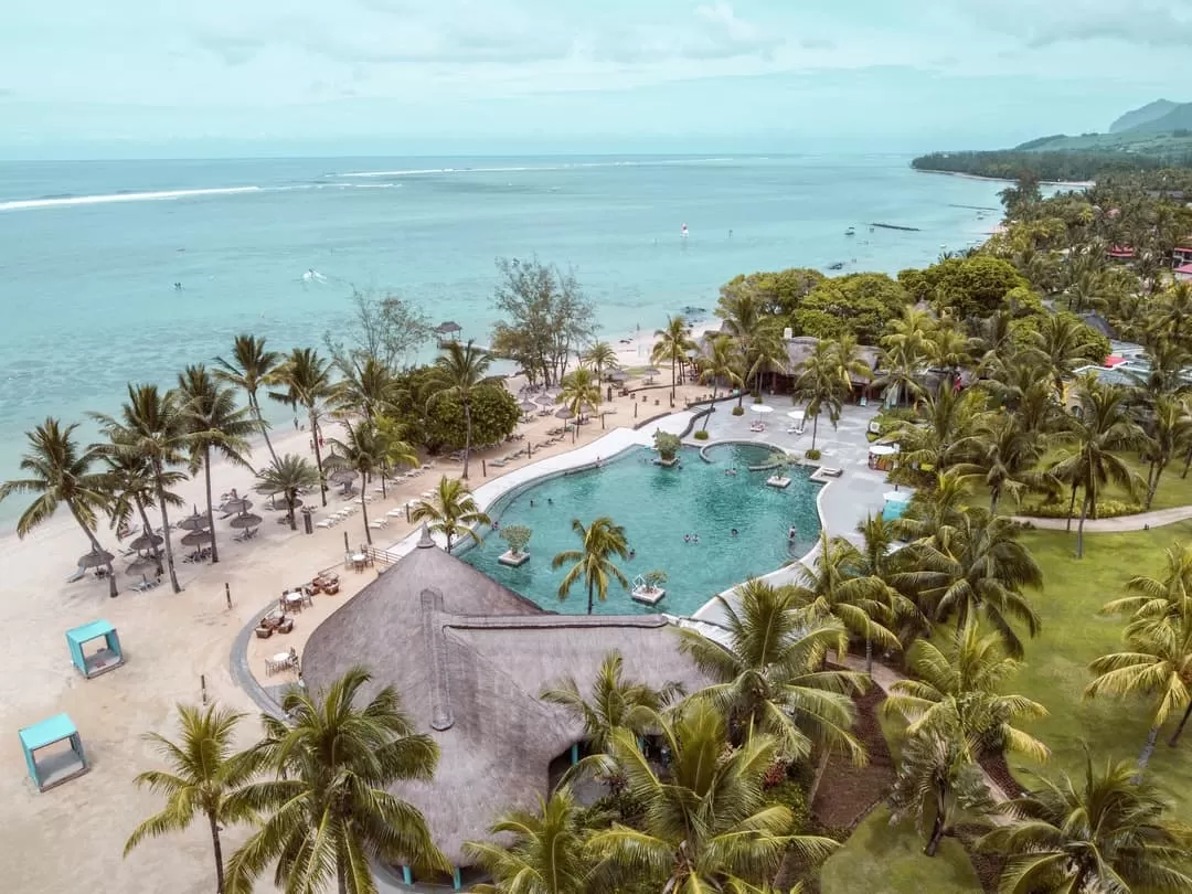 Outrigger Mauritius Beach Resort - Beachfront view with palm trees